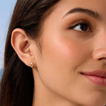 Close-up of a woman wearing a diamond earring with a blurred background