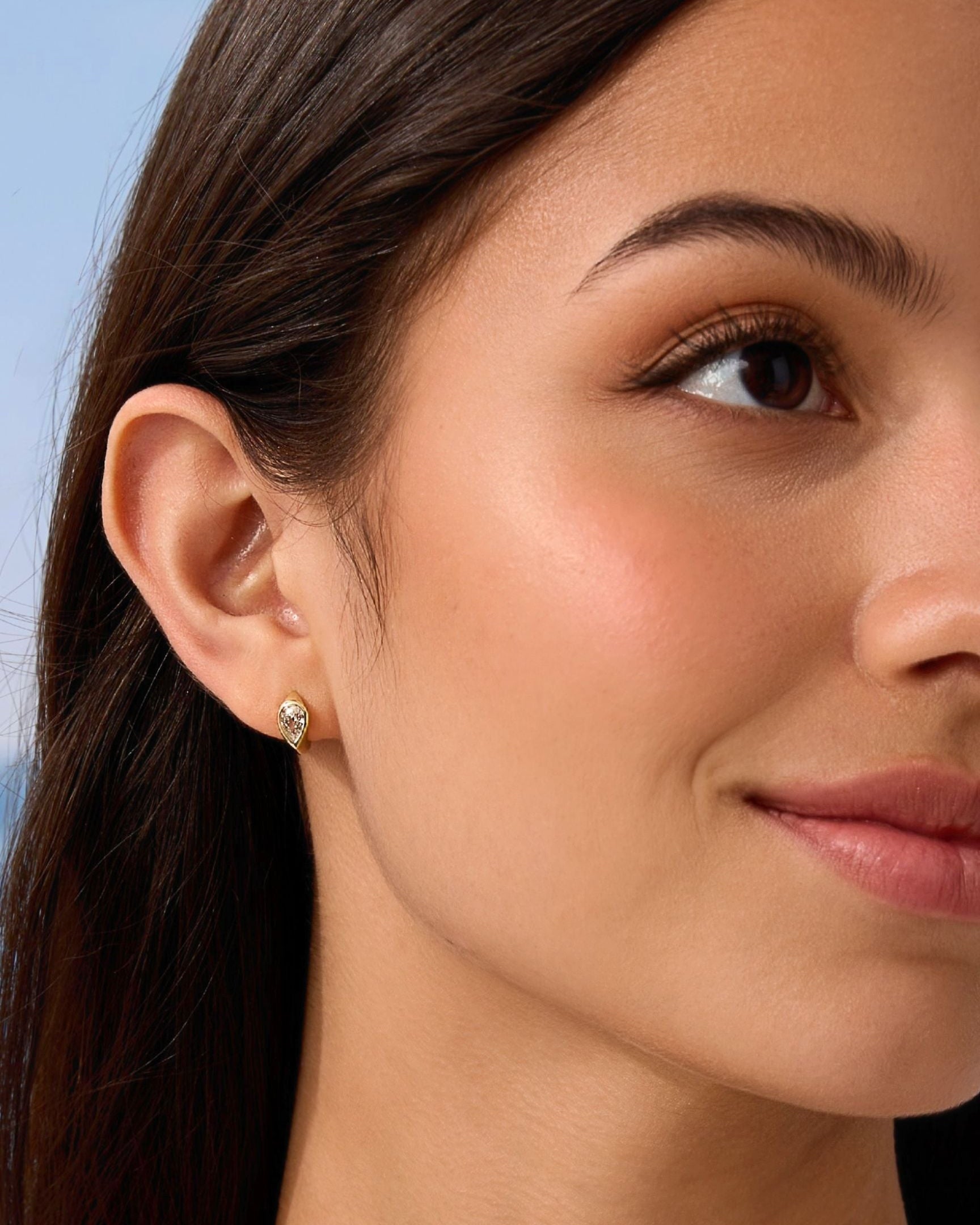 Close-up of a woman wearing a diamond earring with a blurred background